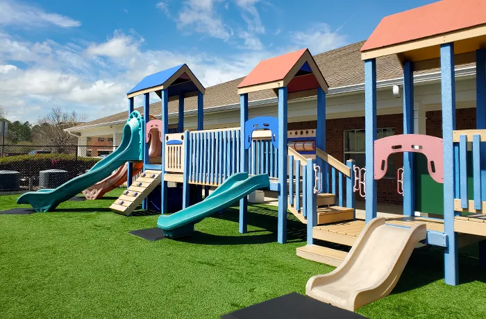 Preschool playground with slides and ramps on turf, completed playground by Pro Playgrounds