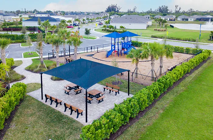 Park with picnic shelter, benches, and playground area, installed by Pro Playground