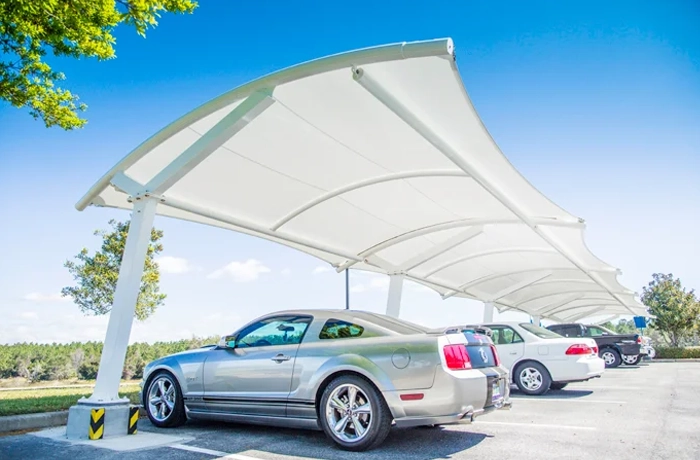 Arched parking lot shade canopy over cars.