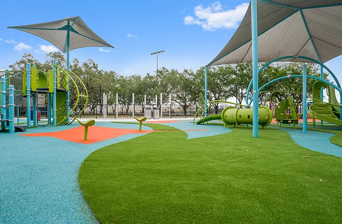 Colorful poured-in-place rubber and turf playground surface, installed by Pro Playgrounds