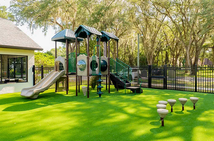Church playground with synthetic turf surface, completed playground surfacing installation by Pro Playgrounds