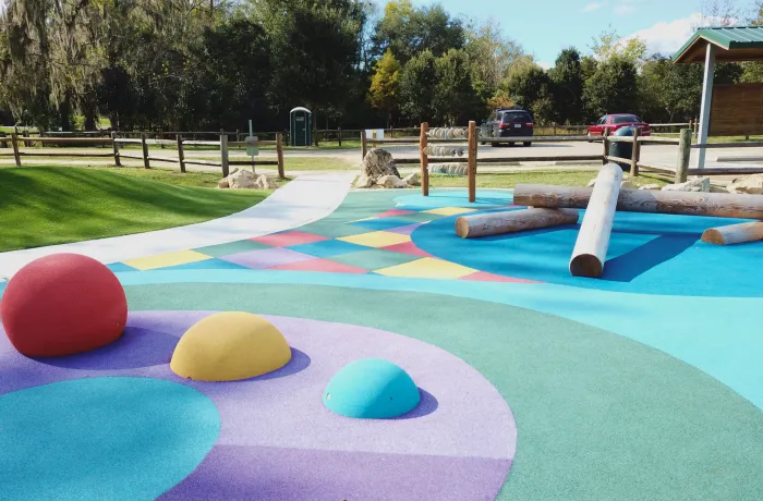 Play area with rubber mounds, completed playground surfacing installation by Pro Playgrounds
