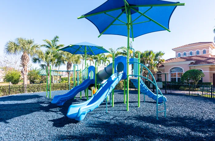 Blue rubber mulch under playground equipment, installed by Pro Playgrounds