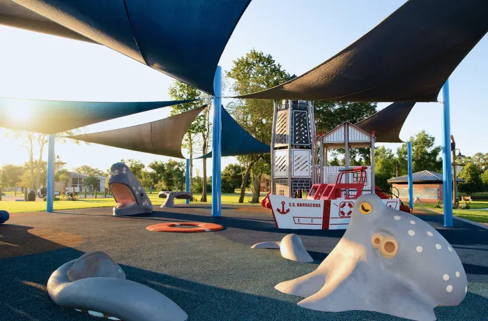 Completed shade structure installation by Pro Playgrounds with multiple triangular sail shades over playground