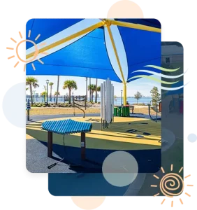 Completed shade structure installation by Pro Playgrounds with blue and yellow sail shade over playground