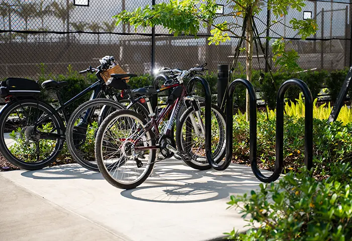 Commercial bike rack with bicycles parked, installed by Pro Playgrounds