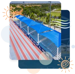 Completed shade structure installation by Pro Playgrounds with blue shade canopies over track bleachers