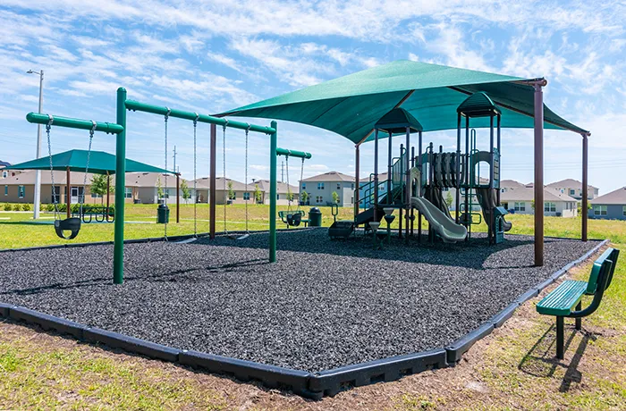 Swing set and shaded play structure, completed playground by Pro Playgrounds for neighborhood.