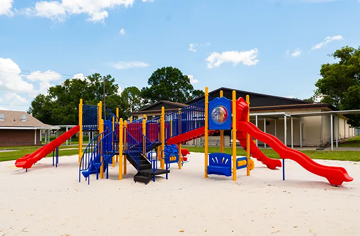 Completed school playground by Pro Playgrounds with large red and blue play structures.