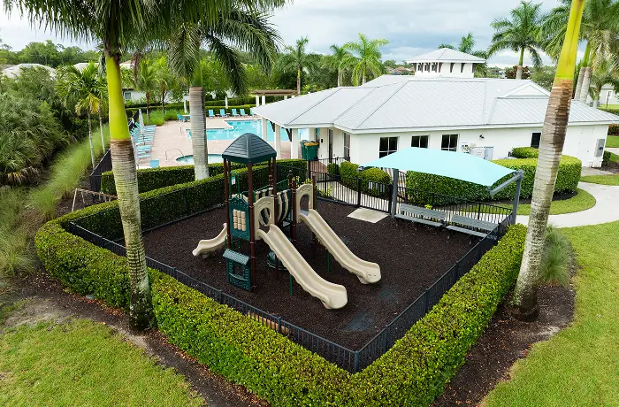 Completed playground by Pro Playgrounds inside a fenced resort play area