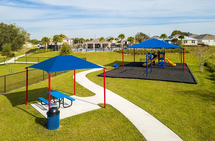 Completed playground by Pro Playgrounds with shaded play structure and picnic area
