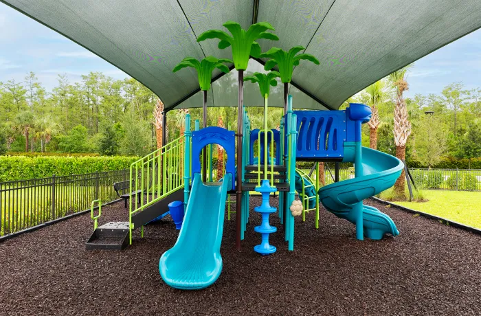 Completed playground by Pro Playgrounds with slides and climbing elements under canopy