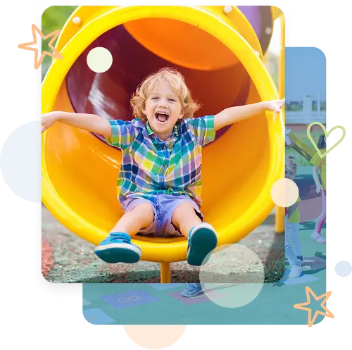 Child sliding down yellow tube slide on preschool playground